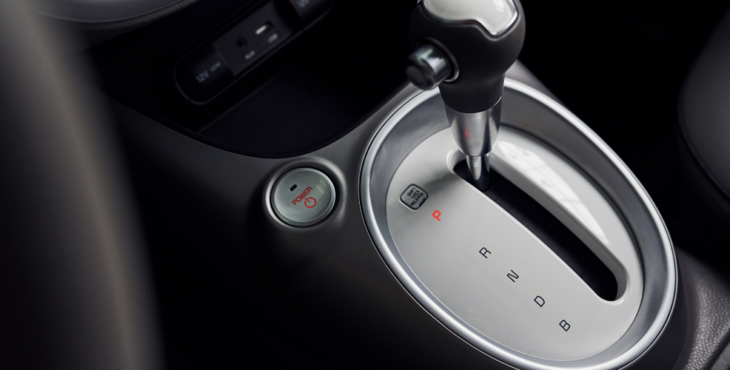 Close-up view of an automatic car's gear stick, showcasing its sleek design and functional features.