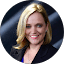 A woman with blonde hair in a blue blazer reviews services at Eric's Car Care.