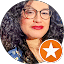 A woman with curly hair and glasses provides a review at Eric's Car Care.