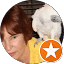 A woman with a white bird on her shoulder, providing reviews at Eric's Car Care.