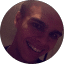 A cheerful man in a circle with a black backdrop, highlighting customer reviews at Eric's Car Care.