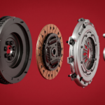 Exploded 3D rendering of an automotive clutch assembly on a dark red background, showing the flywheel, friction disc, pressure plate, and release bearing aligned from left to right.